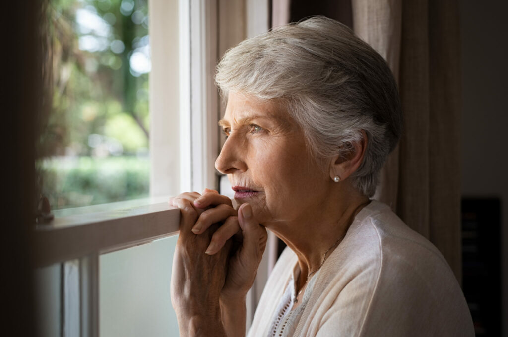 Senior woman looking out window